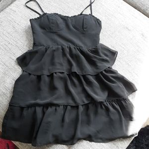 Ruffled black mini dress with a structured top